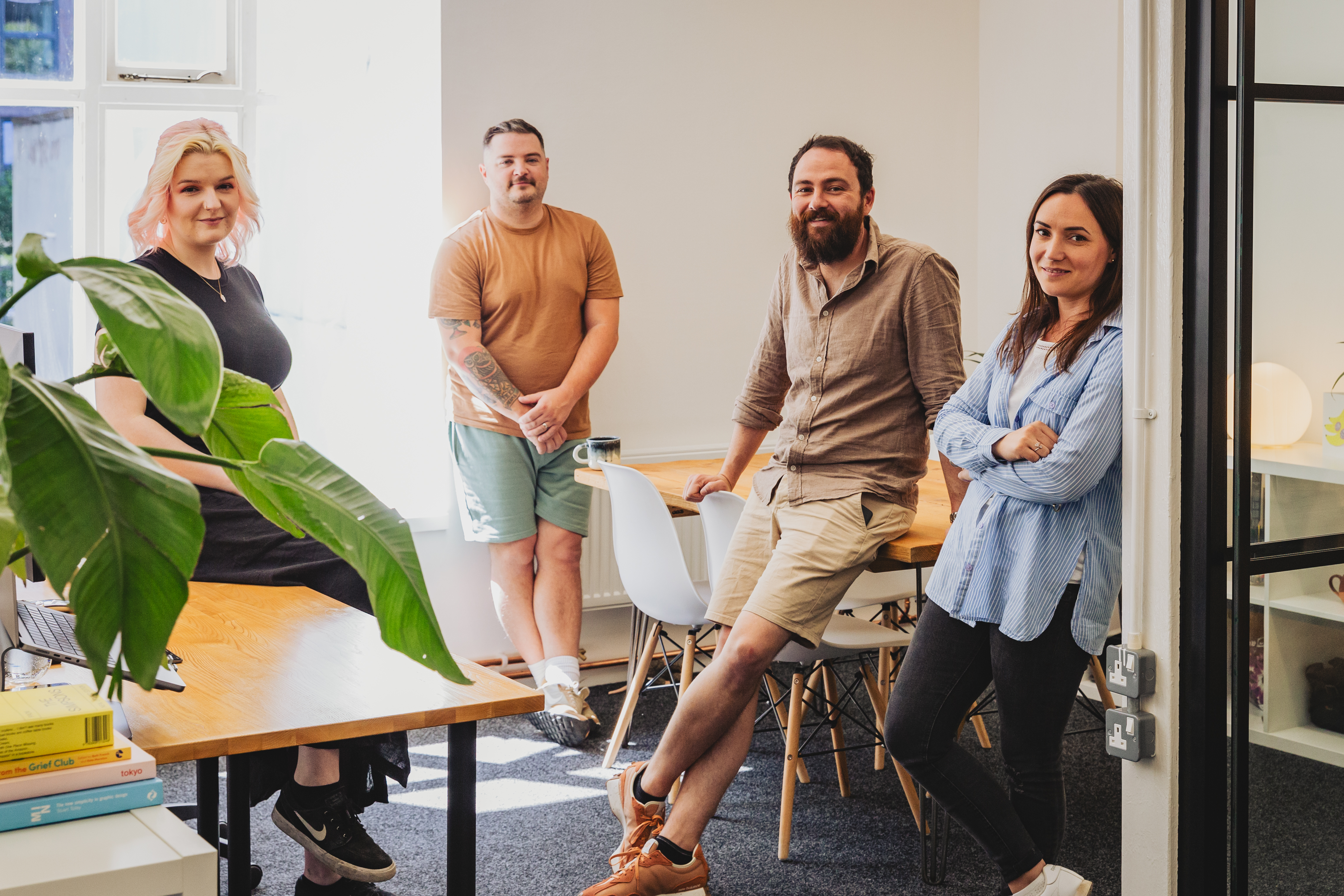 The Few and Far team pose in their Leeds office, two men and two women are shown